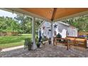 Cozy backyard patio with outdoor seating, barbecue and lush green lawn at 508 Faulkner St, New Smyrna Beach, FL 32168