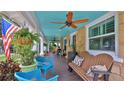 Inviting front porch with comfortable seating, plants, and an American flag at 508 Faulkner St, New Smyrna Beach, FL 32168