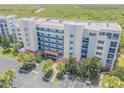 Aerial view of a condo building with beautiful marsh views from the rooftop at 5300 S Atlantic Ave # 9-206, New Smyrna Beach, FL 32169