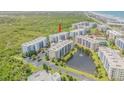 Gorgeous aerial view of a condo community with a pond and fountain in the center at 5300 S Atlantic Ave # 9-206, New Smyrna Beach, FL 32169