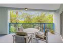 Cozy balcony with seating area and lovely views of surrounding trees and clear skies at 5300 S Atlantic Ave # 9-206, New Smyrna Beach, FL 32169