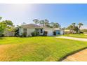 Charming home featuring a well-maintained lawn and a two-car garage with a spacious driveway at 5430 Dubois Ave, Port Orange, FL 32127