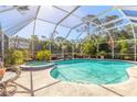 Screened pool with attached hot tub and lots of surrounding tropical foliage at 5430 Dubois Ave, Port Orange, FL 32127