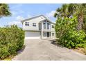 Inviting two-story home with a spacious driveway and a well-maintained front yard at 6361 Turtlemound Rd, New Smyrna Beach, FL 32169