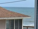 Enjoy breathtaking ocean views from this cozy home with classic wood shingles at 6361 Turtlemound Rd, New Smyrna Beach, FL 32169