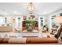 Spacious living room with modern lighting, decor, comfortable seating, and a view into the kitchen at 6542 Rover Way, St Cloud, FL 34771