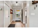 Bright entryway with hardwood flooring, neutral walls, and a view to the exterior through a glass front door at 706 Sky Tree Ct, New Smyrna Beach, FL 32168
