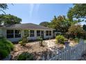 Inviting front yard with stepping stones and a white picket fence at 825 E 23Rd Ave, New Smyrna Beach, FL 32169