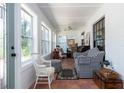 Bright sun room filled with natural light and comfortable seating at 825 E 23Rd Ave, New Smyrna Beach, FL 32169