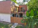 Two-story townhome featuring wood siding, a fenced yard, and a balcony perfect for outdoor living at 95 Moonstone Ct, Port Orange, FL 32129