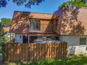 Charming townhome with wood siding, a fenced yard, and upper balcony, perfect for enjoying the outdoors at 95 Moonstone Ct, Port Orange, FL 32129