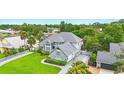 Beautiful home featuring lush landscaping, a gray roof, and a spacious driveway at 128 Godfrey Rd, Edgewater, FL 32141