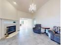 Inviting living room featuring a fireplace, chandelier, and spacious layout perfect for relaxation at 1307 Wayne Ave, New Smyrna Beach, FL 32168