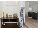 Inviting entryway with dark wood table, decor, and a glimpse into the living area beyond at 135 12Th St, Daytona Beach, FL 32117