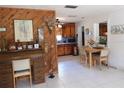 Open concept dining area and desk with wood-paneled accent wall adjacent to the kitchen at 1627 Umbrella Tree Dr, Edgewater, FL 32132