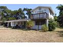 Two-story home featuring a sunburst decoration above a second story balcony at 1627 Umbrella Tree Dr, Edgewater, FL 32132