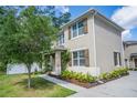 Two-story home with shutters, neutral colors, mature landscaping, a sidewalk, and a charming front porch at 1674 Coulter Ln, Port Orange, FL 32129