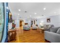 Bright living room featuring hardwood floors, recessed lighting, and comfortable seating at 1786 Taylor Rd, Port Orange, FL 32128