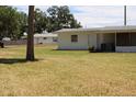 View of the backyard, including lush green grass and views of the home at 1830 Needle Palm Dr, Edgewater, FL 32132