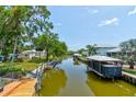 Scenic waterfront view with docks and boat lifts, offering direct access to the water for boating enthusiasts at 184 Azalea Rd, Edgewater, FL 32141