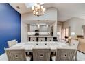 Open-concept dining room showcasing modern lighting, accent wall, views to a gourmet kitchen, and plenty of natural light at 1903 Sprucewood Way, Port Orange, FL 32128