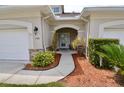 Inviting front entrance with decorative shrubs and mulched flower beds around the walkway at 1903 Turnbull Lakes Dr # 1903, New Smyrna Beach, FL 32168