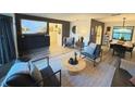 Well-decorated living room with modern furniture, neutral colors, and seamless flow to the dining area at 208 Wellington Dr, Daytona Beach, FL 32119
