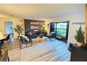 Cozy living room featuring stylish furniture, a large bay window, and neutral decor at 208 Wellington Dr, Daytona Beach, FL 32119