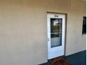 Inviting entrance with a white trimmed door, welcome mat, and elegant glass detail for a touch of charm at 2100 N Peninsula Ave # 2160, New Smyrna Beach, FL 32169