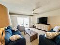 Comfortable living room features stylish sofas, a modern ceiling fan, and sliding doors to the lanai at 2100 N Peninsula Ave # 2160, New Smyrna Beach, FL 32169