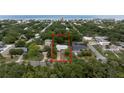 An aerial view highlights the property's location among lush trees and close proximity to the ocean at 2107 Saxon Dr, New Smyrna Beach, FL 32169