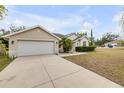 Well-maintained home featuring an attached two-car garage and freshly cut lawn at 2435 Alton Rd, Deltona, FL 32738