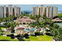 Beautiful resort-style pool area featuring lush landscaping, a charming gazebo, and inviting lounge chairs surrounded by palm trees at 250 Minorca Beach Way # 206, New Smyrna Beach, FL 32169