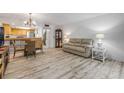 Open-concept living room with dining area and access to the kitchen at 257 Club House Blvd, New Smyrna Beach, FL 32168