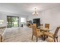 Open-concept living room with balcony access, and dining space at 257 Club House Blvd, New Smyrna Beach, FL 32168