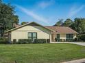 Well-maintained backyard with healthy green grass and pruned shrubbery, offering a serene outdoor space at 257 Sweet Bay Dr, New Smyrna Beach, FL 32168