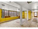 Bright sun room with yellow walls, tile flooring, and a large window to let the sunshine in at 2576 Sunset Dr, New Smyrna Beach, FL 32168