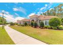 Beautiful single-story home boasting a barrel tile roof and lush, green lawn at 260 Portofino Blvd, New Smyrna Beach, FL 32168