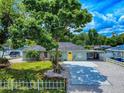 Charming single-story home features a well-manicured lawn and a bright yellow front door at 2714 Yule Tree Dr, Edgewater, FL 32141