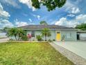 Charming single-story home features a well-manicured lawn and a bright yellow front door at 2714 Yule Tree Dr, Edgewater, FL 32141