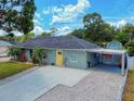 Charming single-story home features a well-manicured lawn and a bright yellow front door at 2714 Yule Tree Dr, Edgewater, FL 32141
