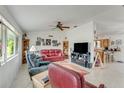 Comfortable living room featuring tile floors, ceiling fan and view into the kitchen at 2726 Victory Palm Dr, Edgewater, FL 32141