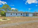Charming single-story home featuring a one-car garage, complemented by a lush green lawn and garden at 2802 English Dr, Deltona, FL 32738