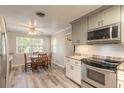 Cozy dining area adjacent to kitchen features a ceiling fan and natural light at 306 Jefferson Ave, Port Orange, FL 32127