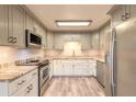 Modern kitchen boasts stainless steel appliances, granite countertops, and ample cabinet space at 306 Jefferson Ave, Port Orange, FL 32127