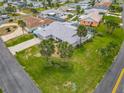 Beautiful overhead view of a well-kept home with a grey roof, green lawn, and mature landscaping at 31 E Sea Harbor, Ormond Beach, FL 32176