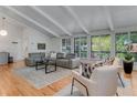 Bright living room with vaulted ceilings, hardwood floors, and large windows at 315 Sweet Bay Ave, New Smyrna Beach, FL 32168