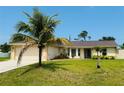Attractive one-story house with a lush green lawn, a wide driveway, and mature landscaping enhancing its curb appeal at 3303 Victory Palm Dr, Edgewater, FL 32141