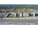 Aerial view of condo buildings with pool and beach access near a residential neighborhood at 3509 S Atlantic Ave # 102 And 103, New Smyrna Beach, FL 32169