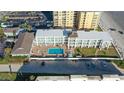 Aerial view of a condo building with a community pool and beach access at 3509 S Atlantic Ave # 102 And 103, New Smyrna Beach, FL 32169